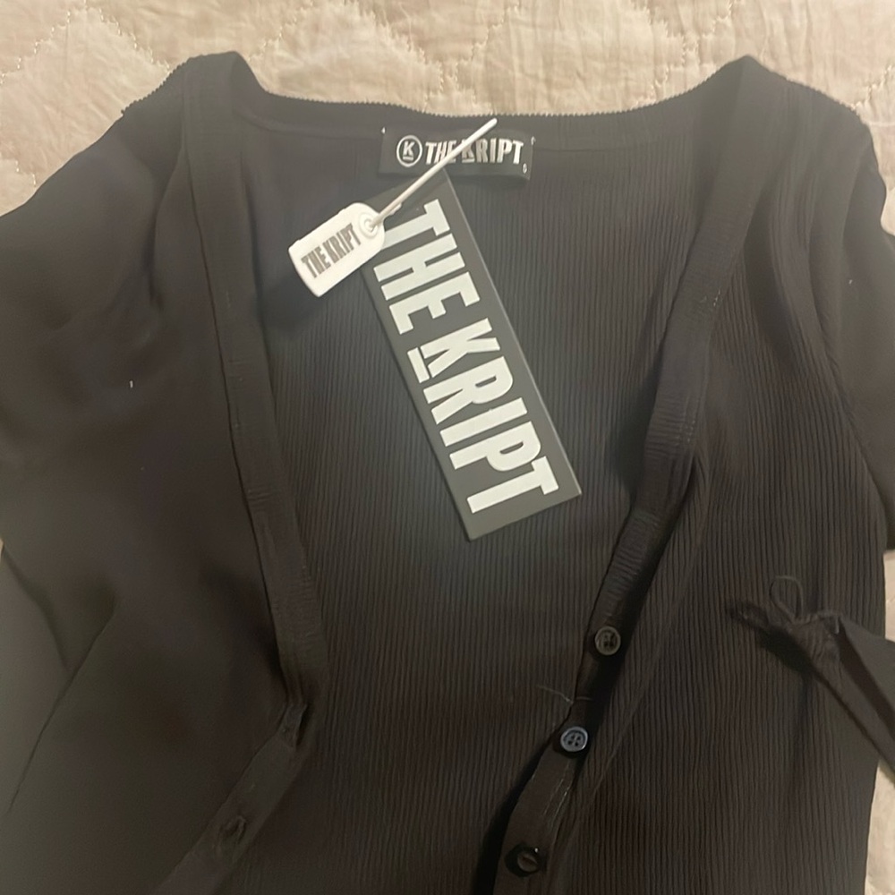Crop button up sweater withh finger hold one need to be stitched.
